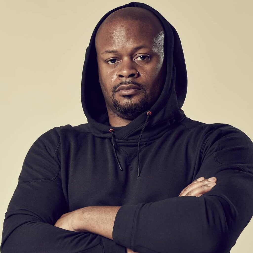 Roderick Shivers, the owner of Power Lift Studio posing in a black hoodie with his arms crossed