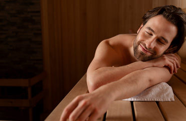 Man with eyes closed enjoys the sauna at Power lift studio in Boston