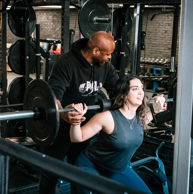 Rod Shivers helping out a female trainee at Power Lift Studio in Boston